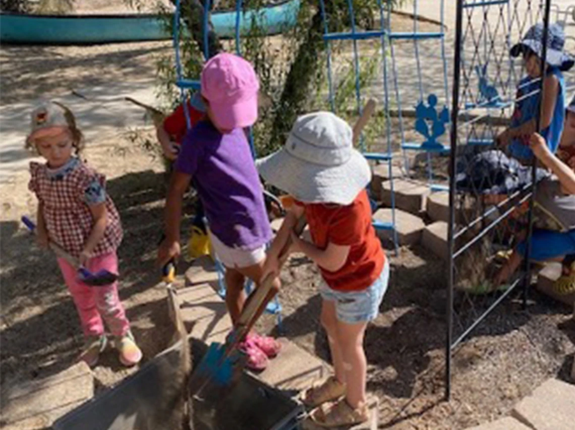 Gathering native soil to mix with compost for soil blocking