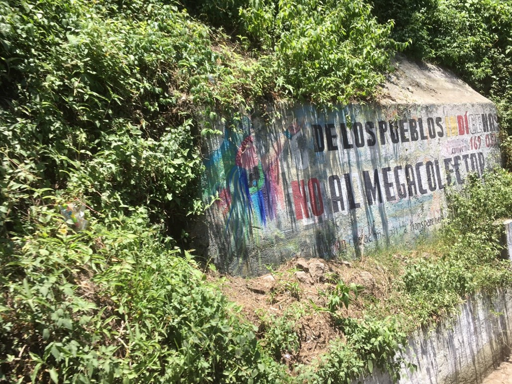 The mural says: “De Los Pueblos Indigenas, NO al Megacolector,” Indigenous Communities Say NO to the Megacolector.